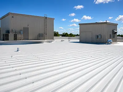 White commercial roof surrounding raised rooftop structures