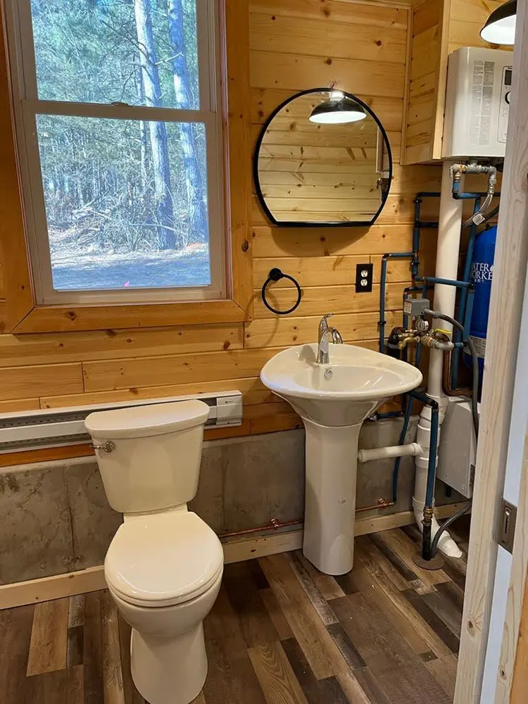 | Troyer Roofing and Construction Bathroom with wood-paneled walls and a window