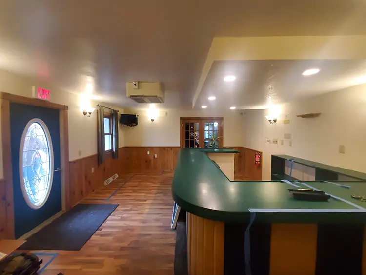 | Troyer Roofing and Construction Finished interior with an entry door, window, and double doors