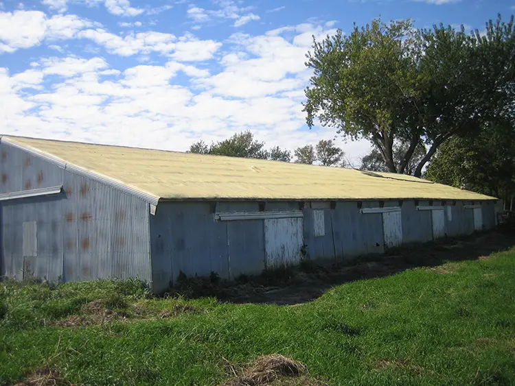 | Troyer Roofing and Construction Worker spraying foam along the edge of a commercial roof