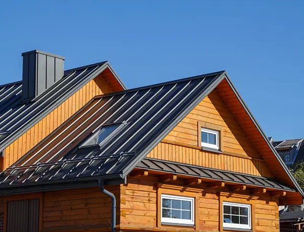 Dark standing seam roof on a wood-sided home